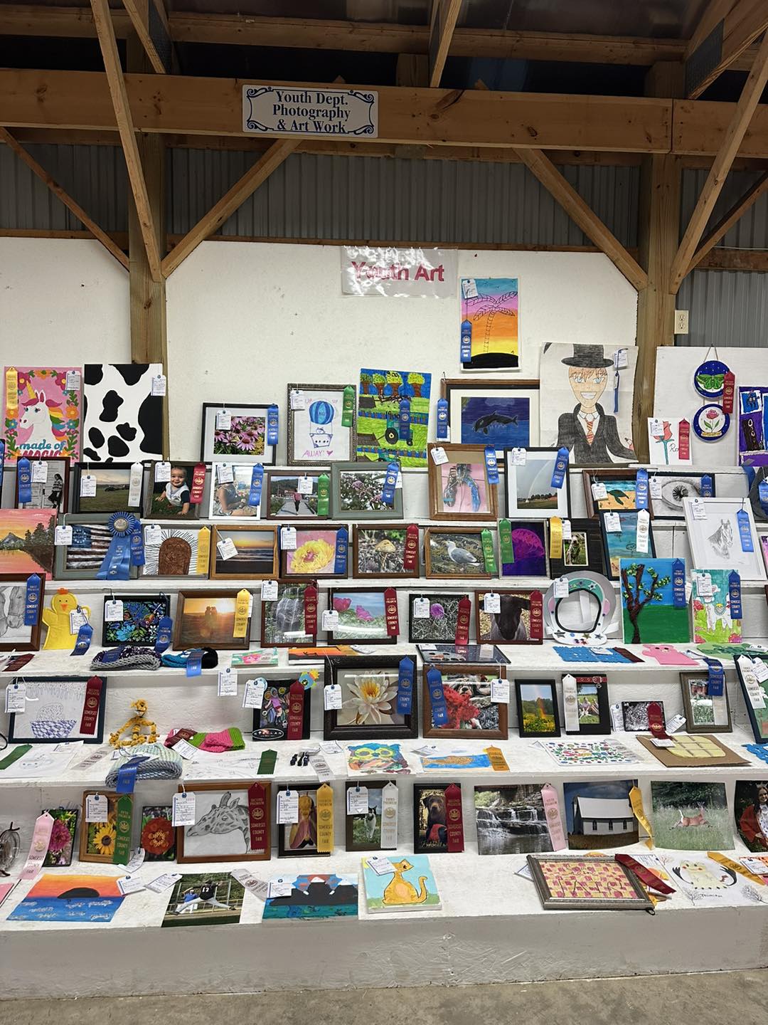 Blue-ribbon quilts and baked goods displayed in the exhibit hall